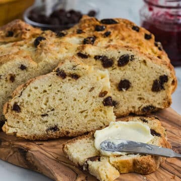 A slice of Irish soda bread slathered with butter.