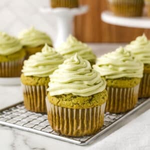 Matcha cupcakes on a cooling rack.