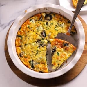 An overhead image of crustless quiche with a serving spoon.