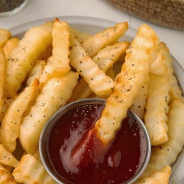 French fries dipped in ketchup.