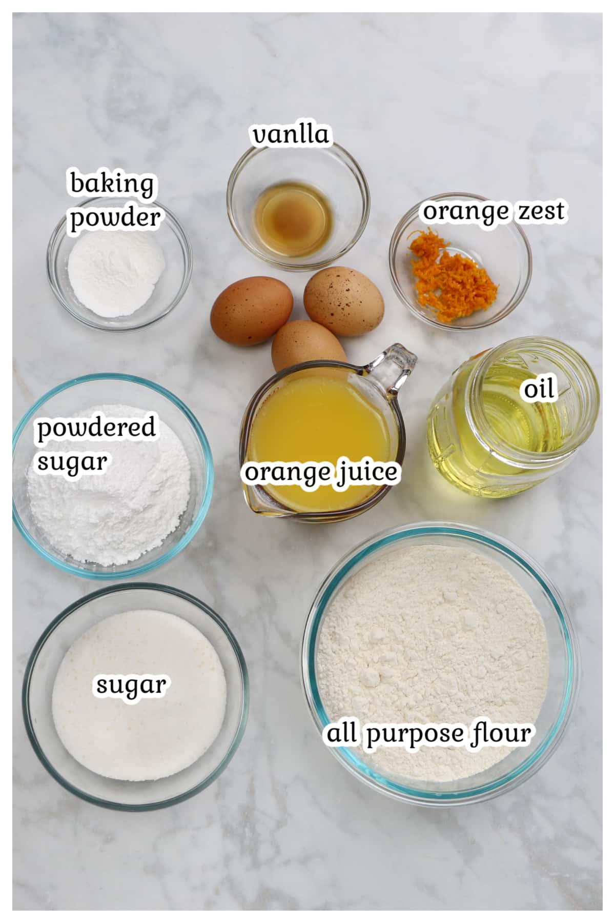 Ingredients for the orange cake on a marble surface.