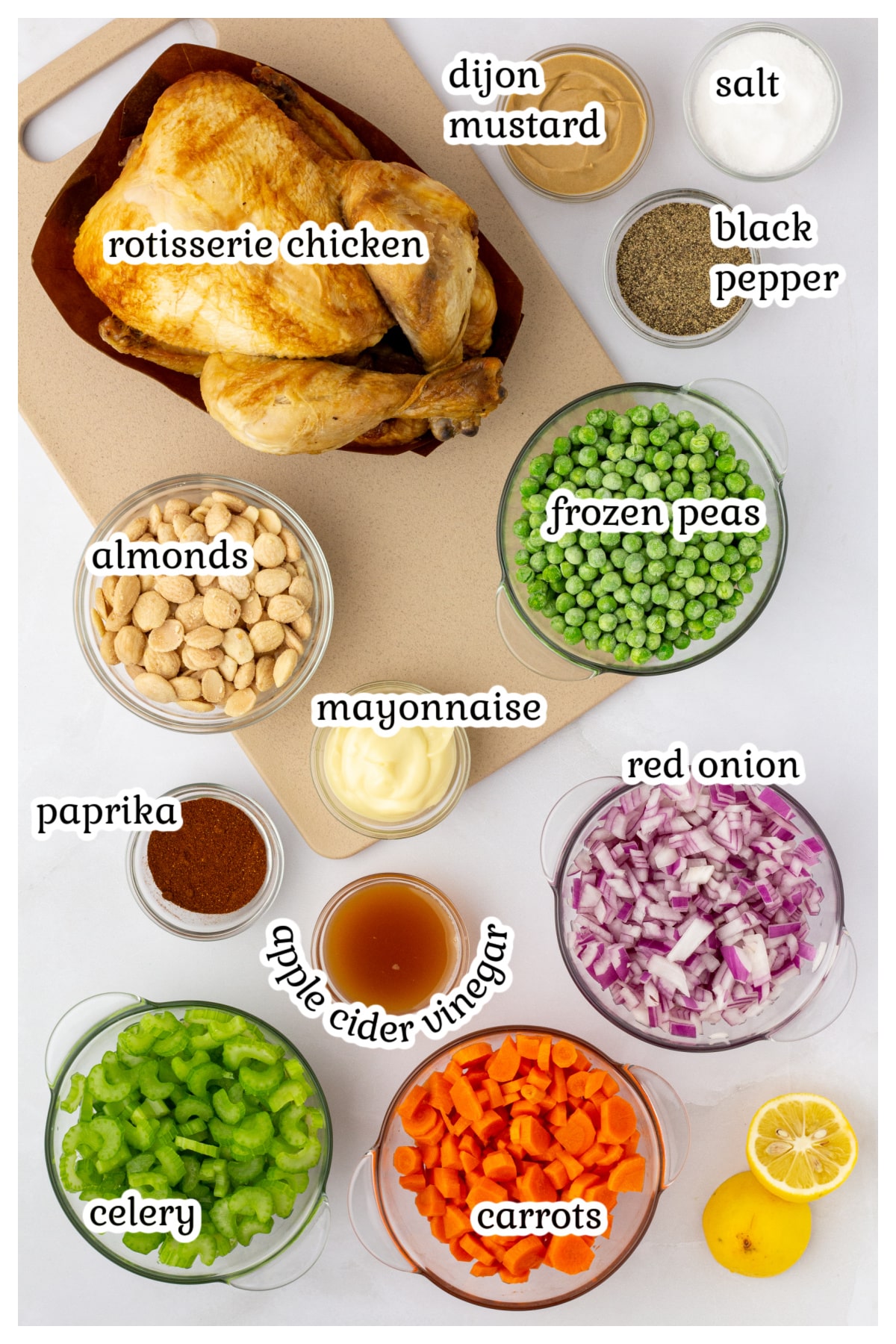 Ingredients for the chicken salad on a white countertop.
