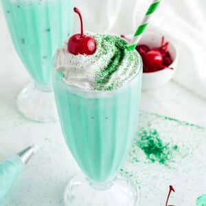 A close up image on a tall glass with shamrock shake.