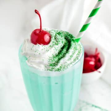 Shamrock milkshake on a tall vintage glass.