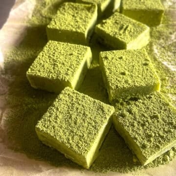 Matcha chocolate squares on a parchment paper.