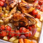 A sheet pan with chicken and vegetables.