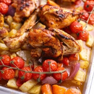 A sheet pan with chicken and vegetables.