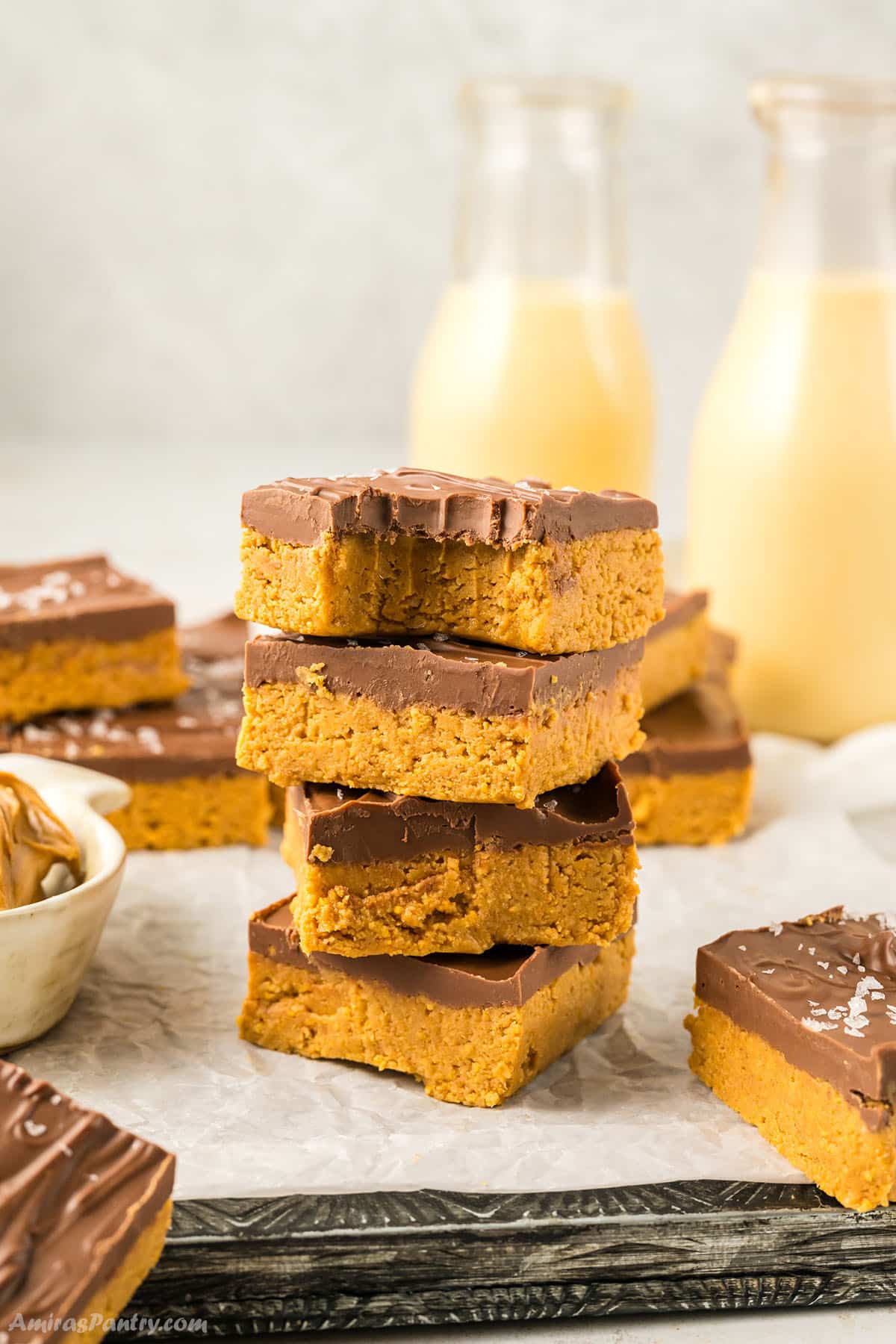No bake peanut butter bars on top of each other with a bite taken from one to show texture.