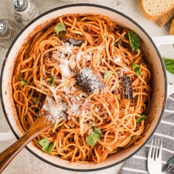 An overhead image of a large pot of pasta garnished with cheese.