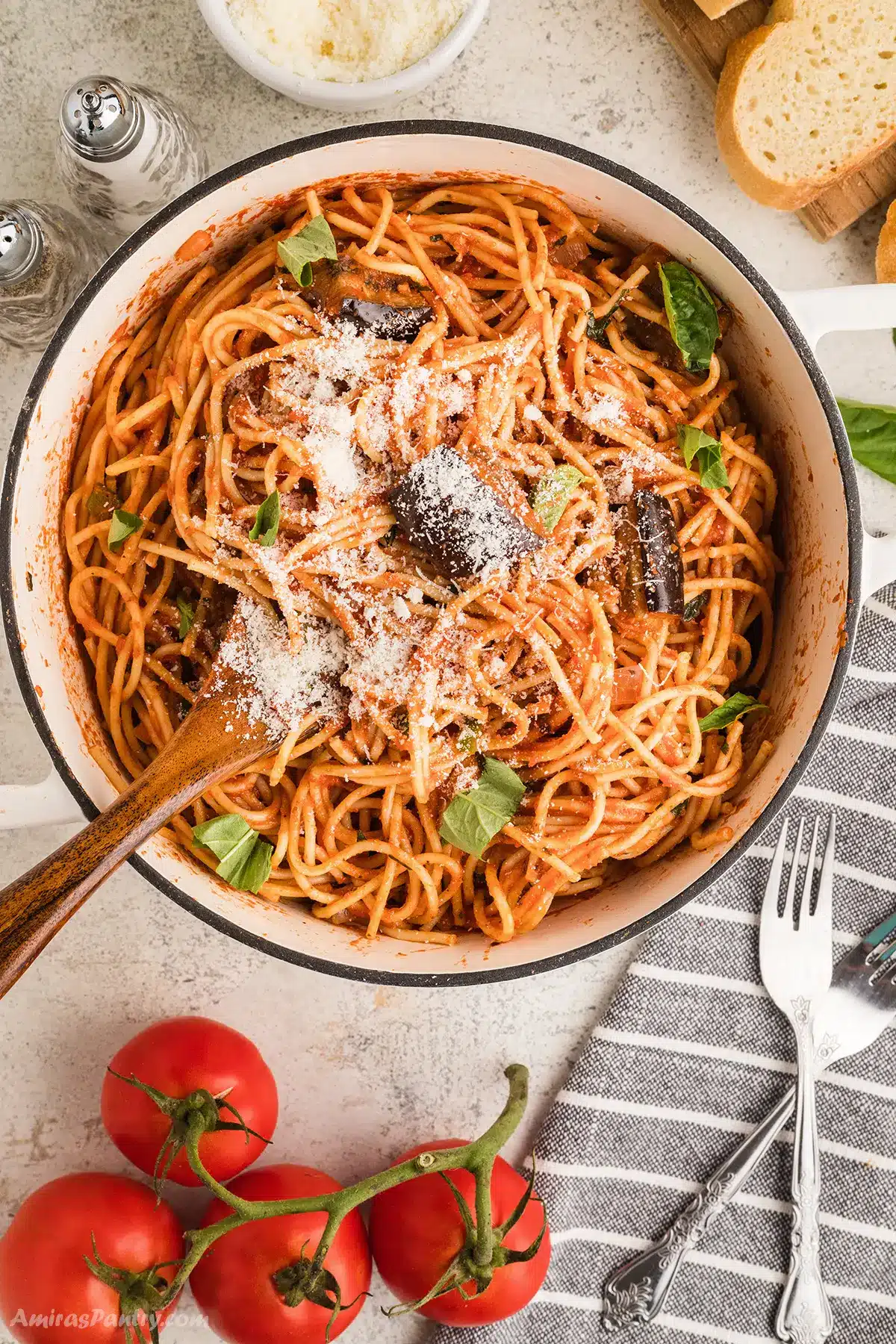 An overhead image of a big pot of pasta with eggplant.