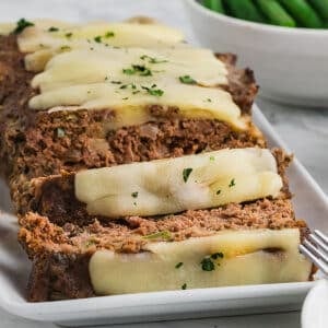 A close up image of thick, juicy slices of meatloaf.