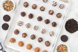 Decorated Oreo balls on a baking sheet.