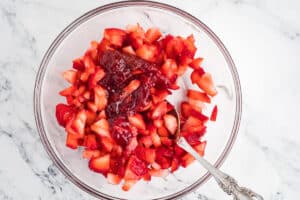 A bowl of strawberry filling mixed together.