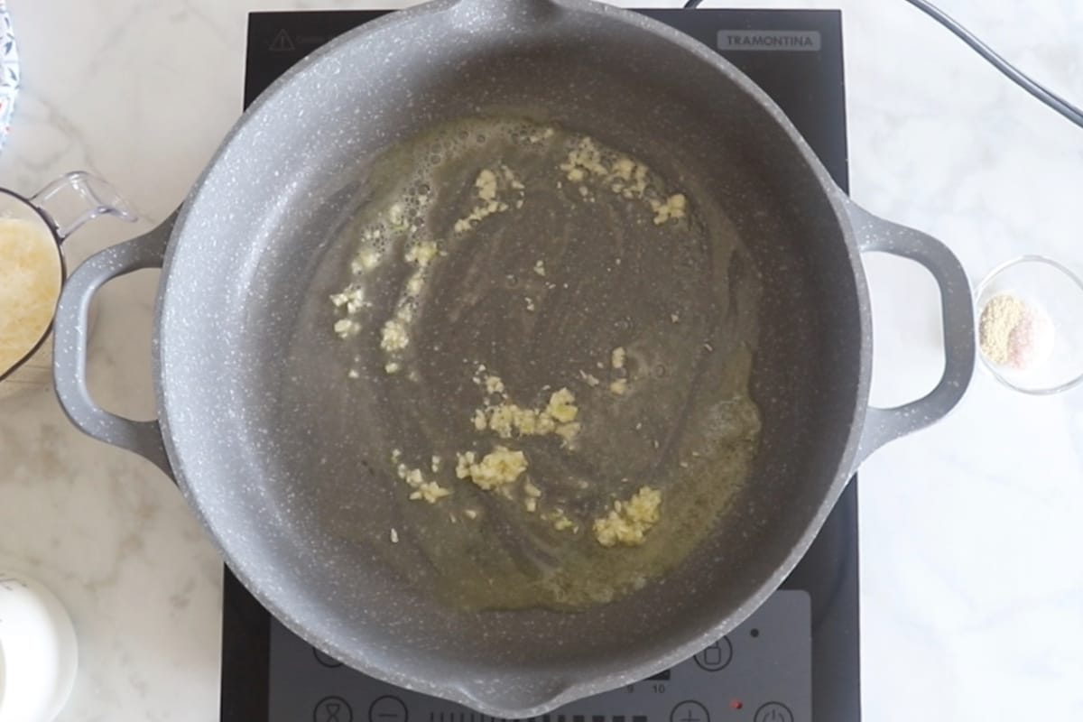 Garlic sauteed in a large skillet.