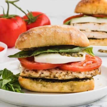 A close up image on a grilled chicken caprese sandwich.