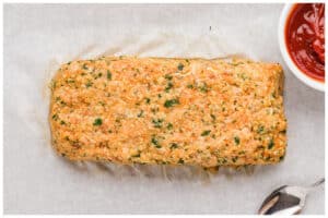 chicken meatloaf shaped on a baking sheet.