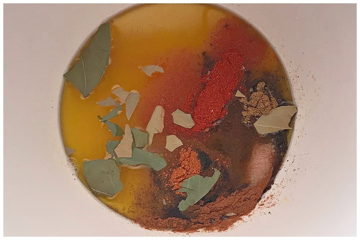 Spices with oil and lemon juice in a bowl.