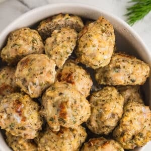 A white bowl with chicken meatballs.