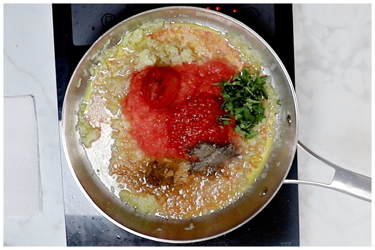 A skillet with harissa pasta sauce in a skillet.