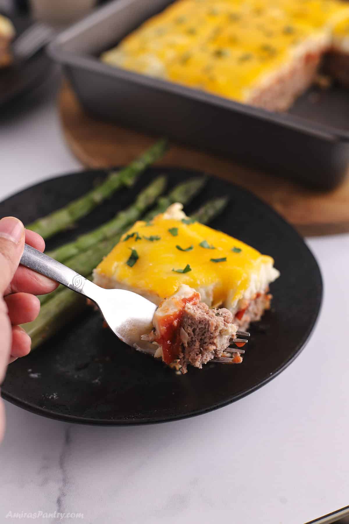 A for cutting a piece of meatloaf casserole with the rest in the back.