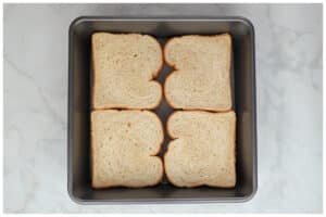 A 9x9 dish with slices of bread at the botoom.