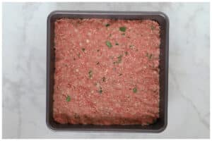 Meatloaf mixture in the casserole.