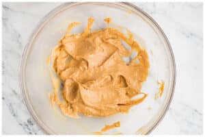 creamed peanut butter and butter in a glass bowl.
