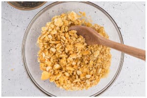 Crackers and butter mixed in a glass bowl.