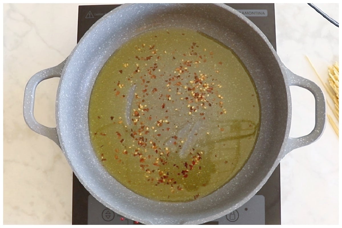 Chili pepper flakes in hot oil.