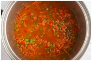Vegetarian orzo ingredients cooked in a stainless steel pot.