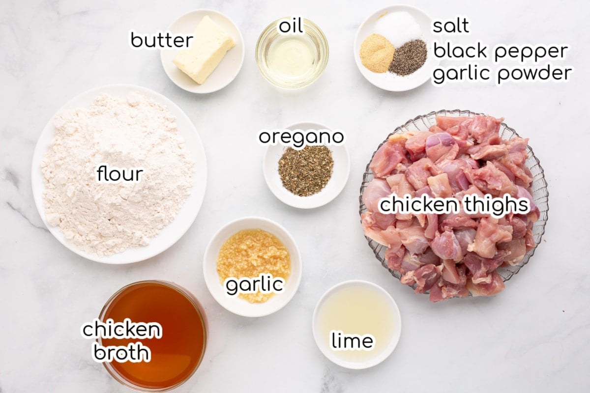 Ingredients for garlic chicken on a white counter.