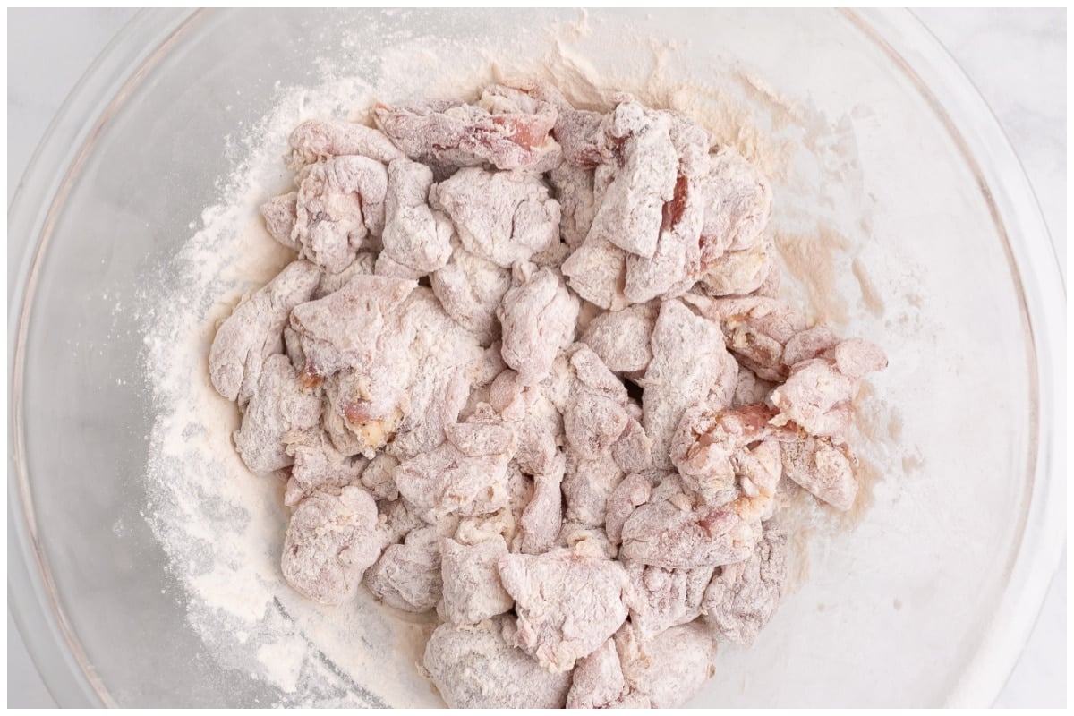 Chicken thighs dredged in flour.