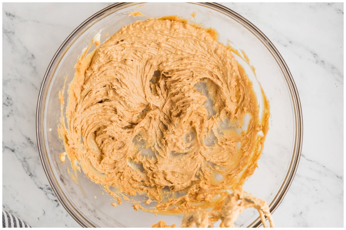 A large bowl of meanut butter mixed with butter.