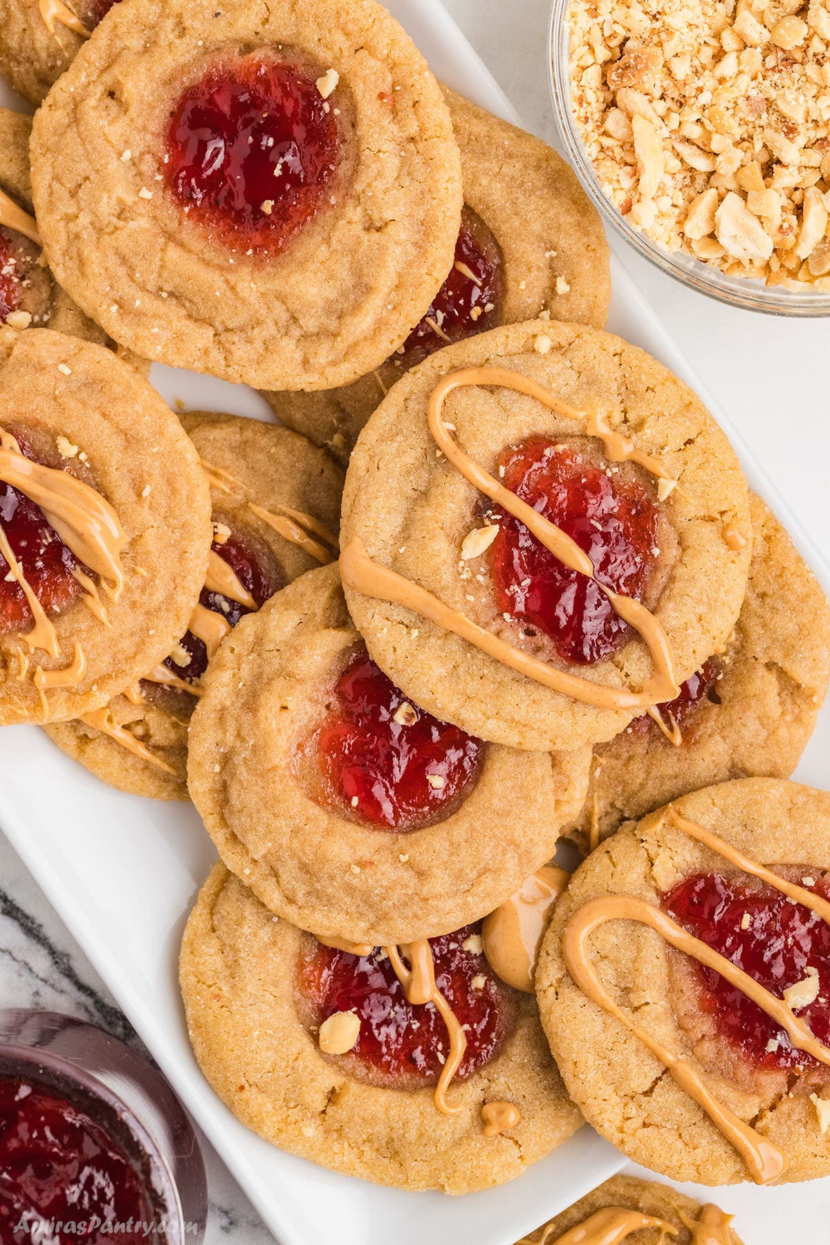 An overhead image of peanut butter cookies on a white serving platter.