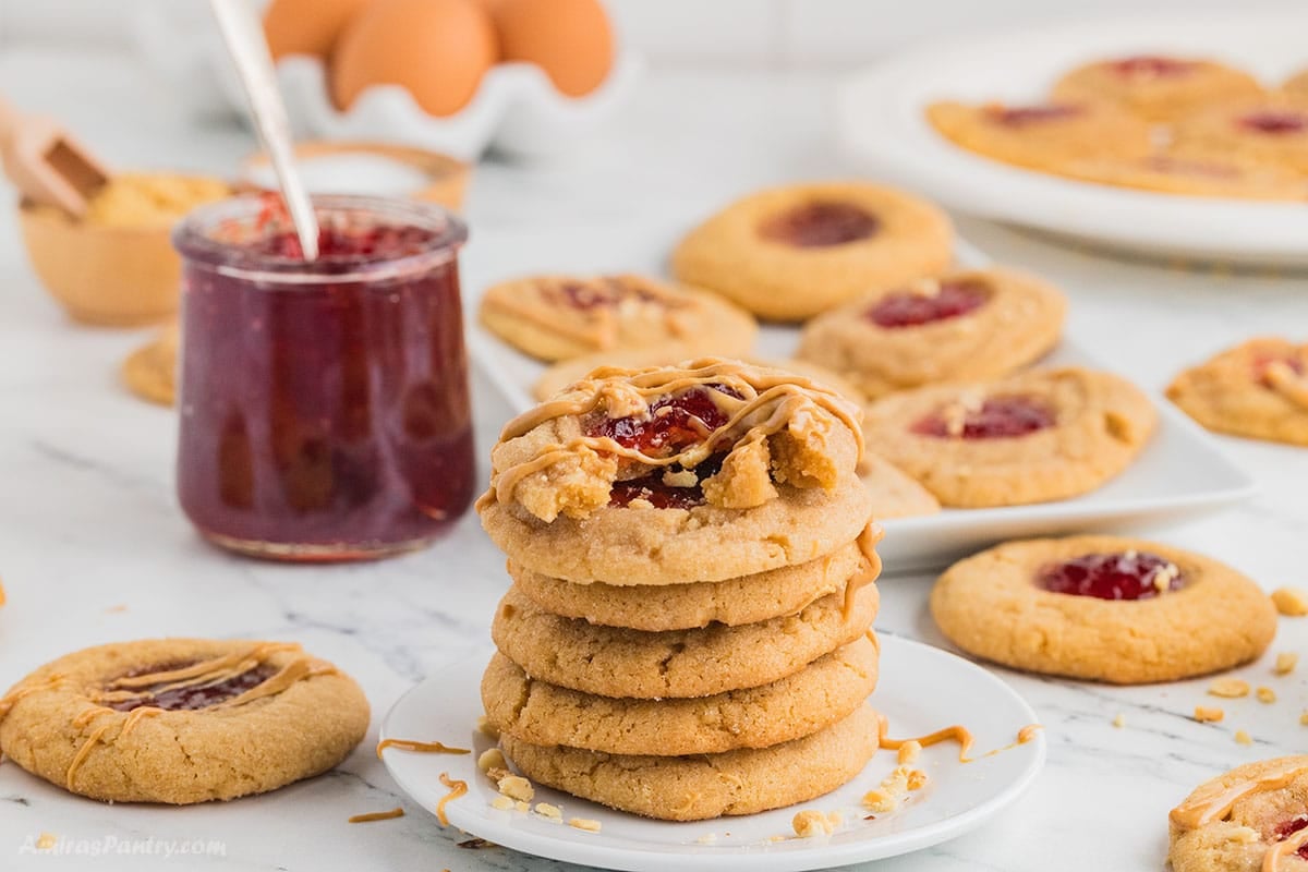 A stack of peanut butter cookies on a white plate.