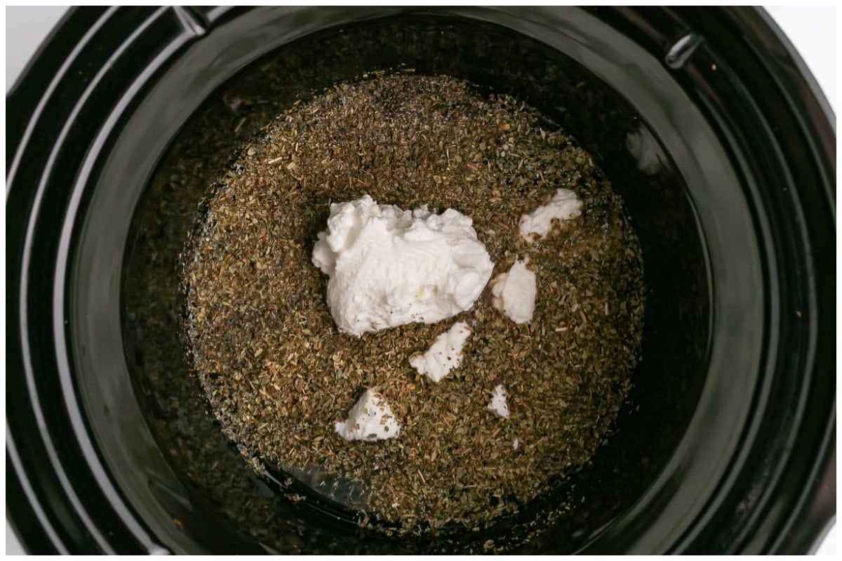Slow cooker with marinade ingredients.