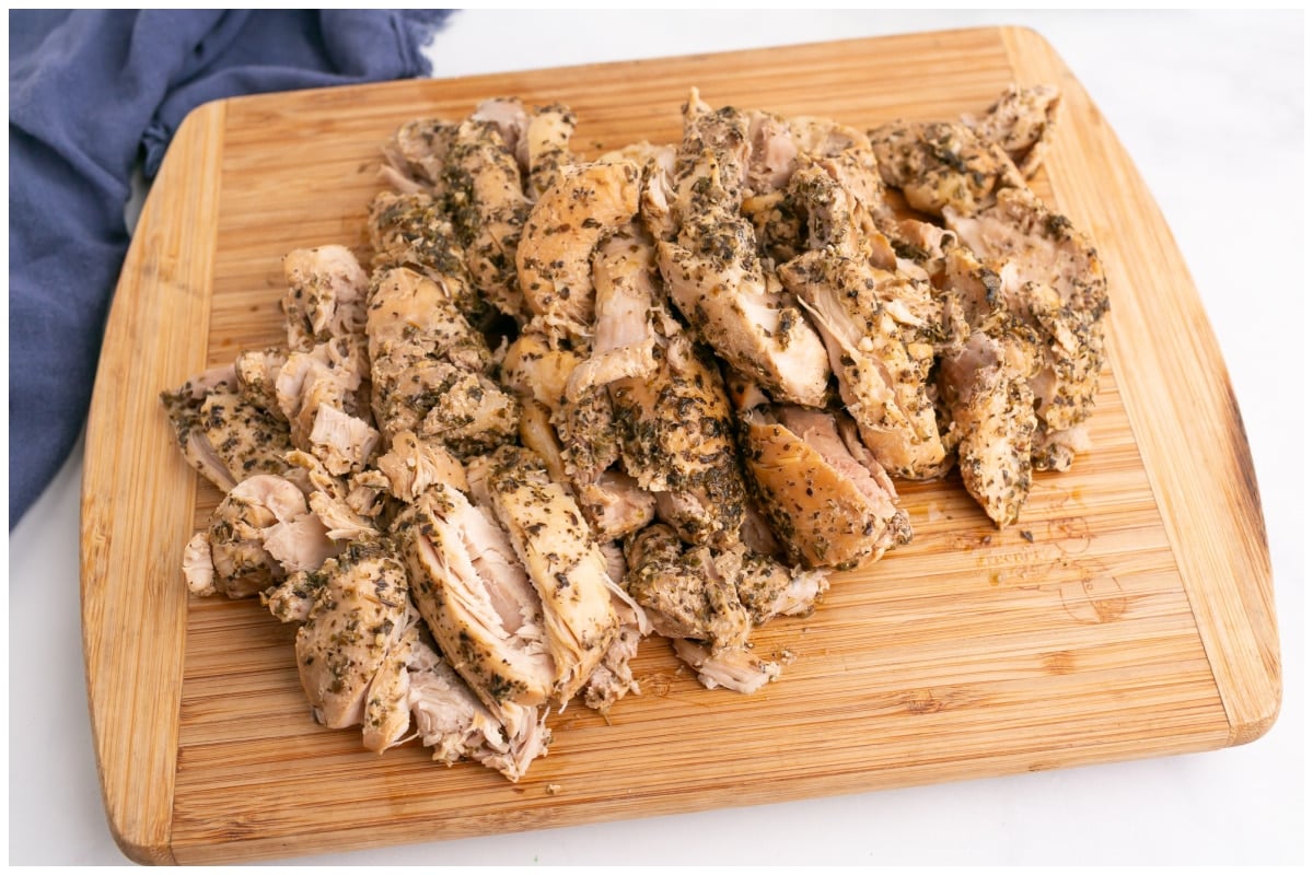 Chicken cut on a wooden cutting board.