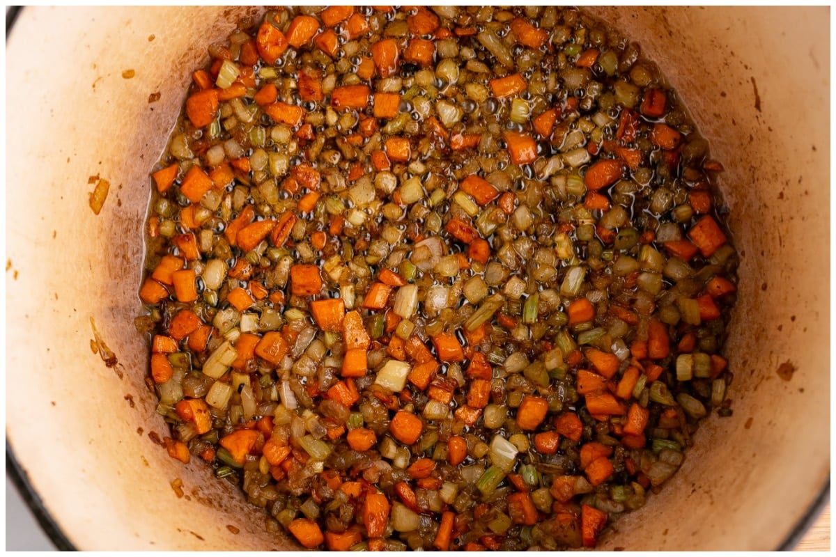 Garlic, onion and vegetables sauteed in a large pot.