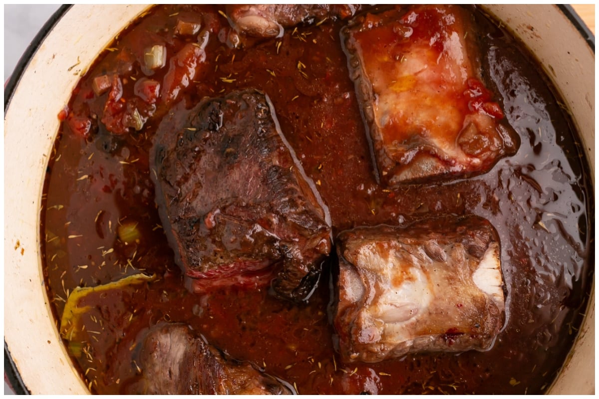 Beef short ribs simmering in sauce.