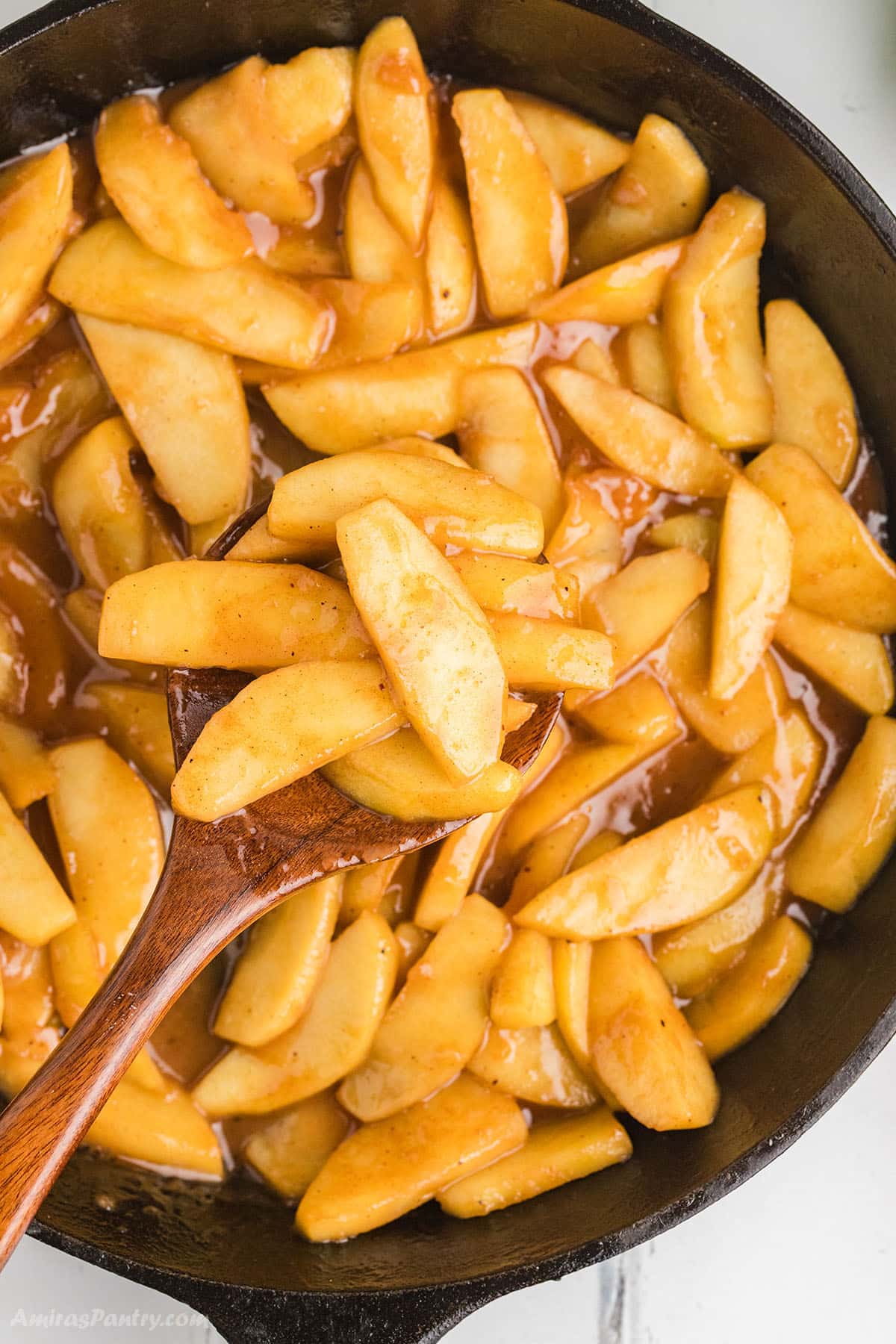 An overhead image of a skillet with fried apples.