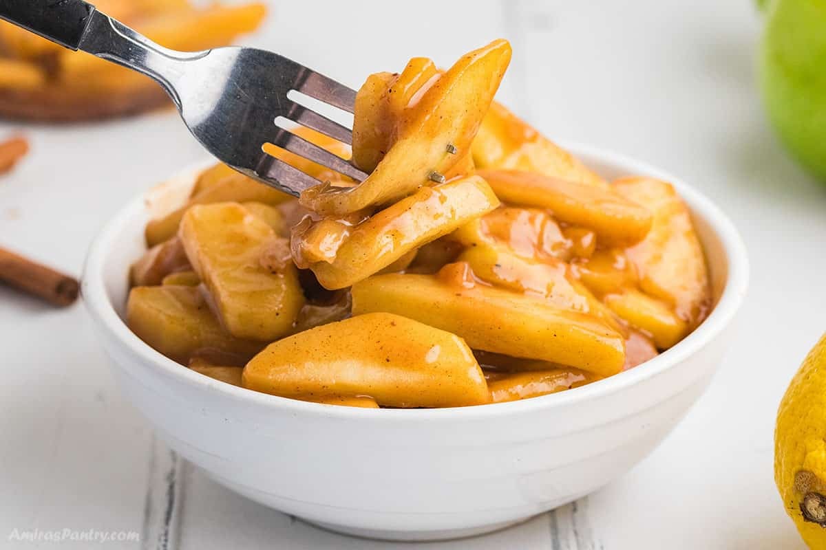 A fork with some fried apples.