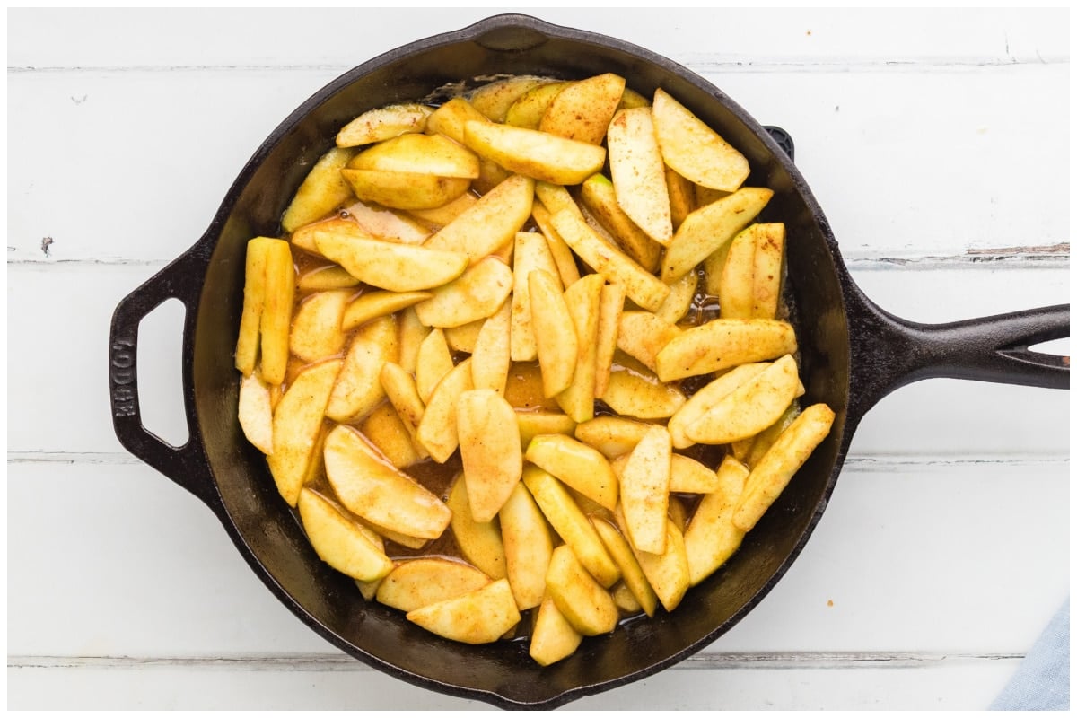 A large skillet with apples and spices.