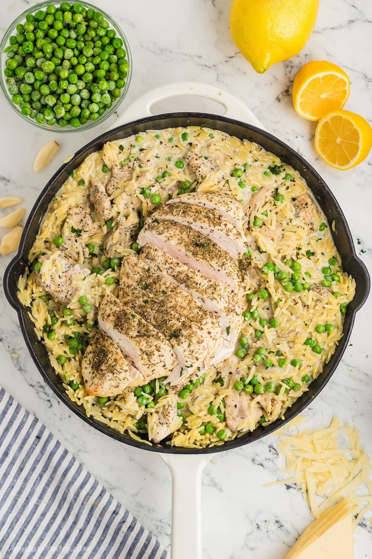 An overhead image of a skillet with lemon chicken orzo.