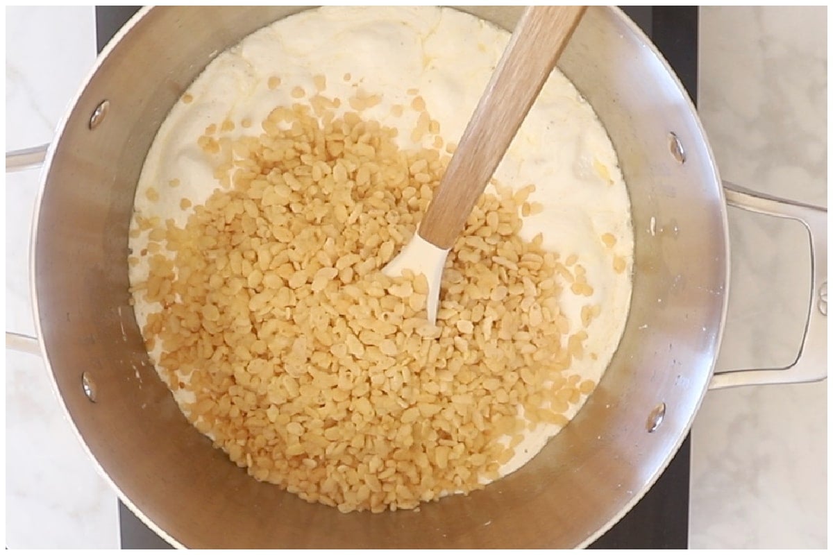 Toasted cereal added to the marshmallow fluff in a large pot.