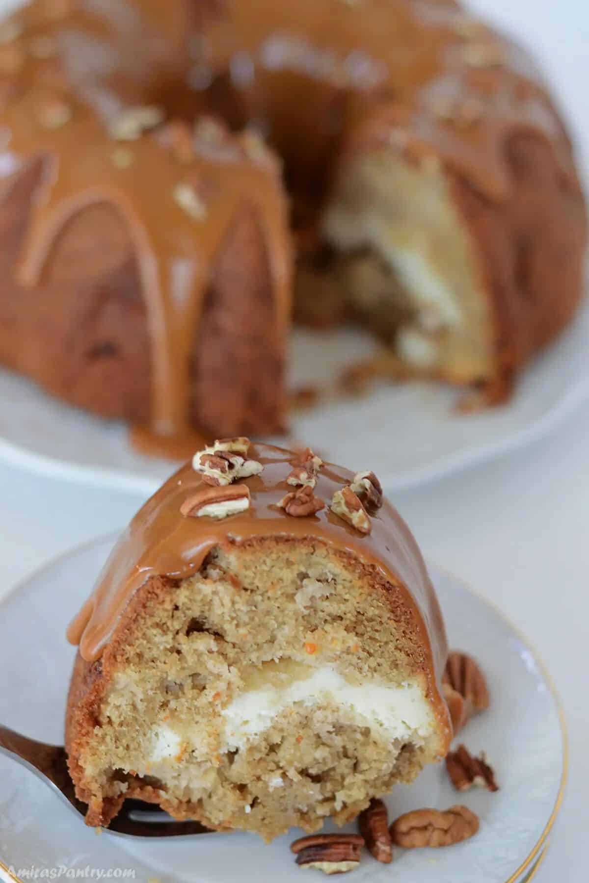 A slice of apple cream cheese bundt cake on a white plate to show texture.