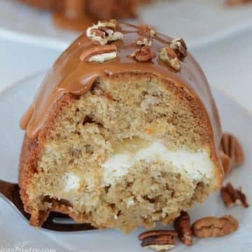 A close up image on a slice of apple cream cheese cake.