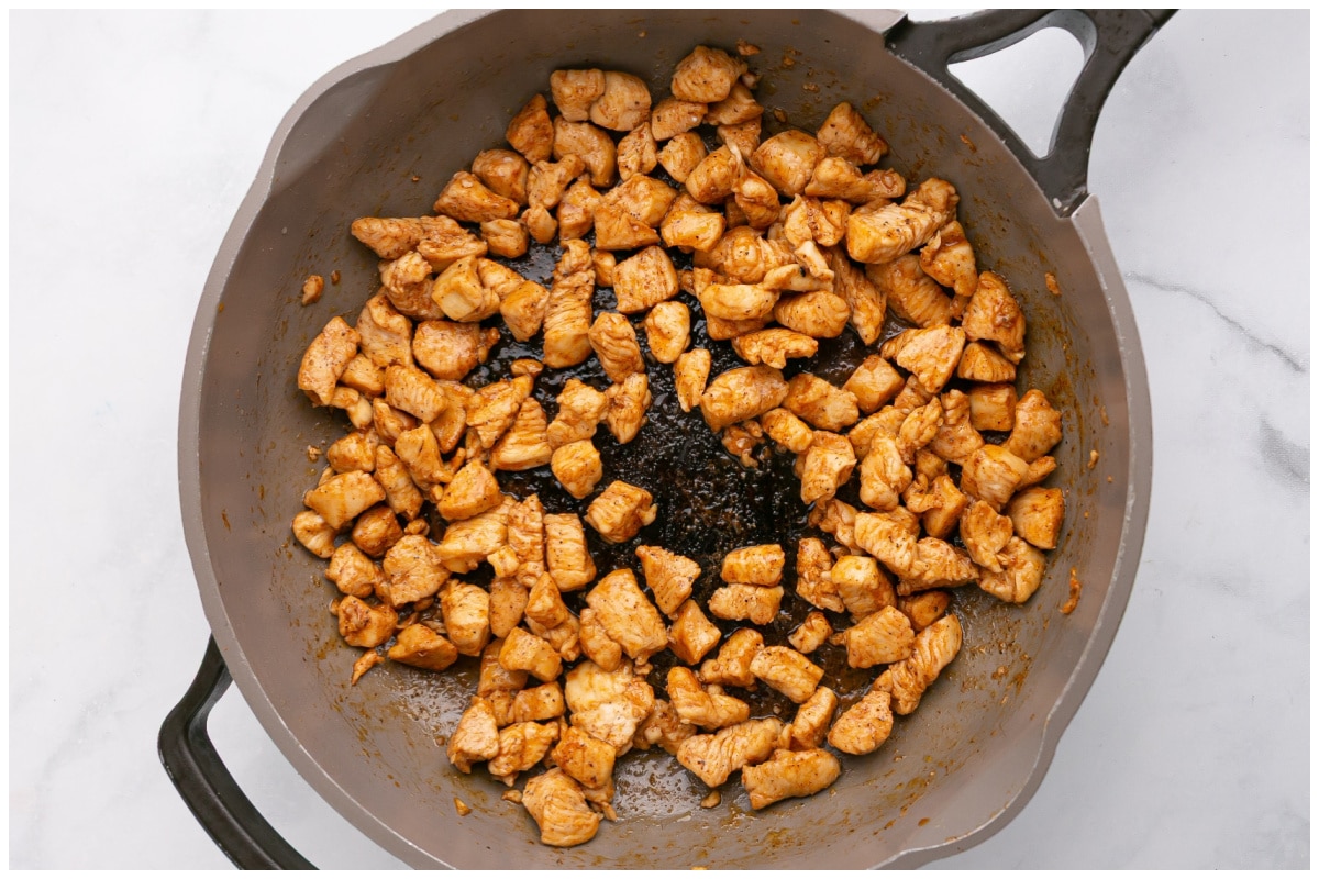 A skillet with cooked chicken.