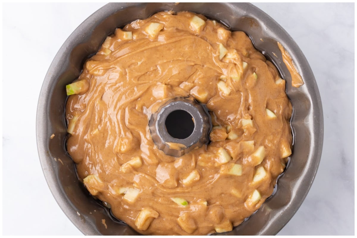 Apple cake in a bundt pan ready to be baked.