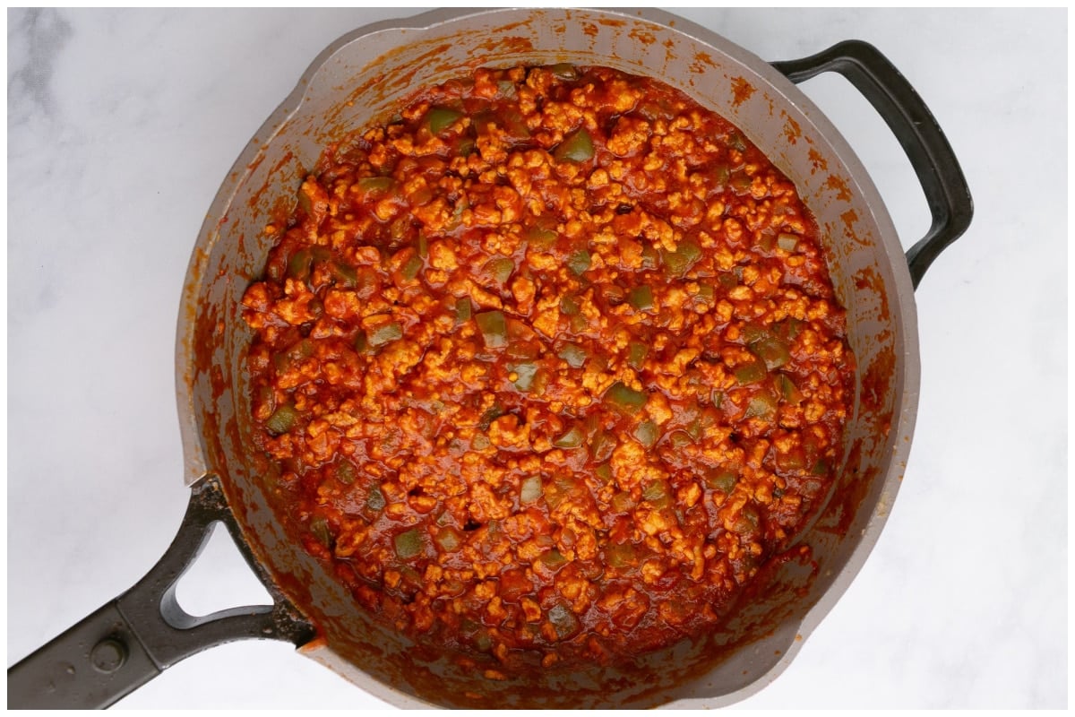 Ground chicken sloppy joes bubbling in a large skillet.