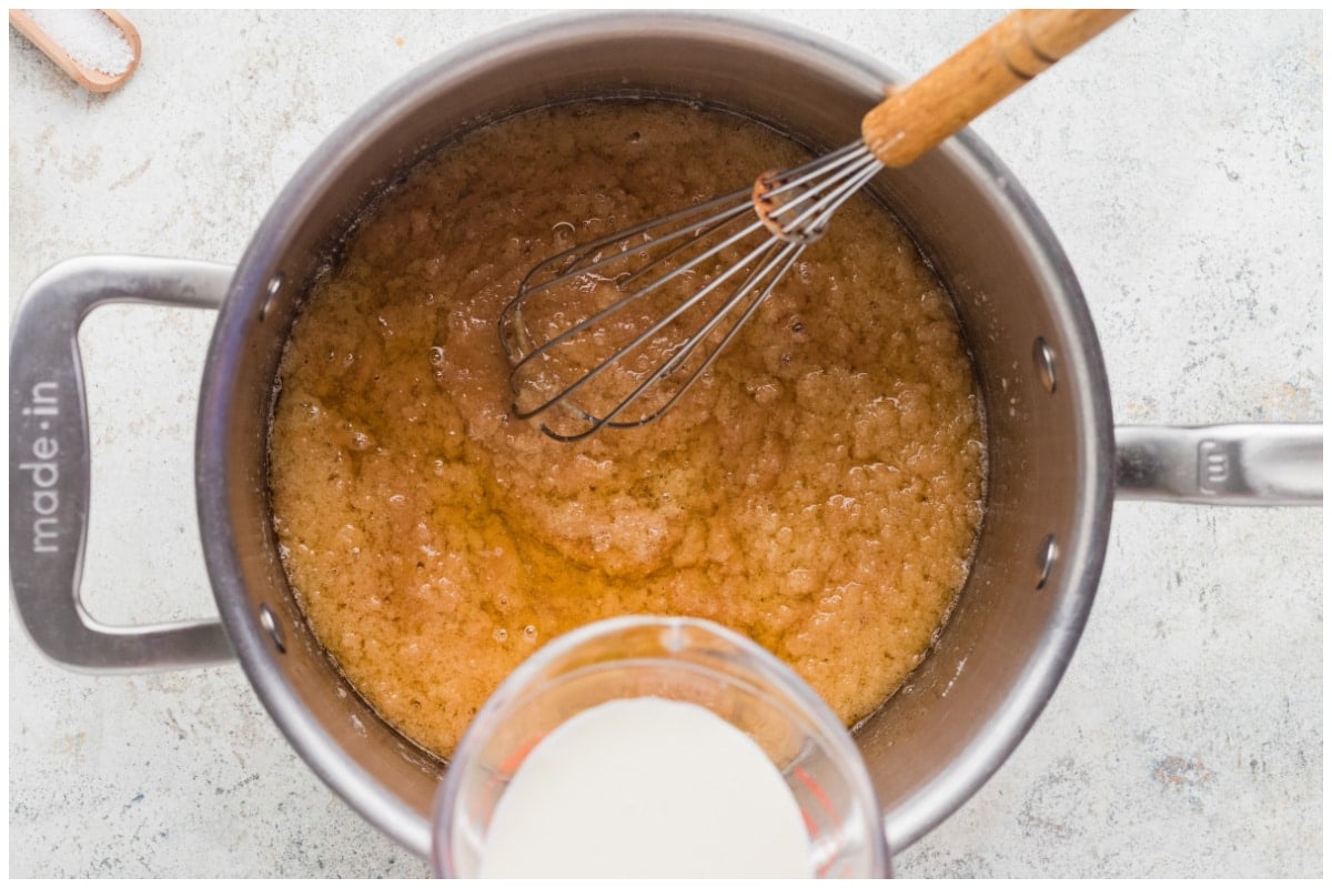Pouring heavy cream over caramel in a sauce pan.